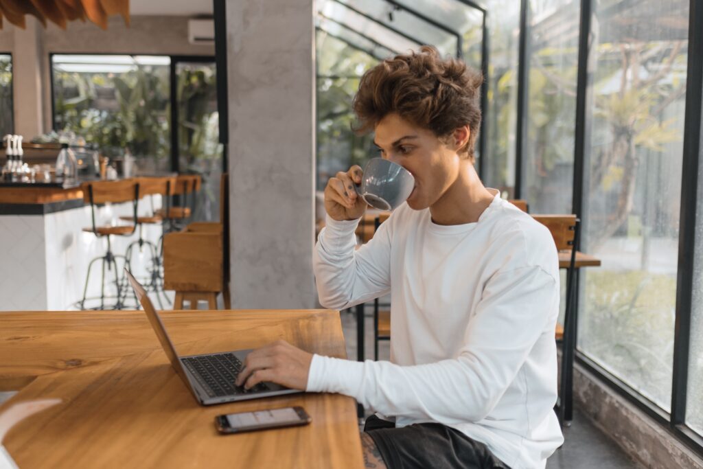 man on laptop with coffee
