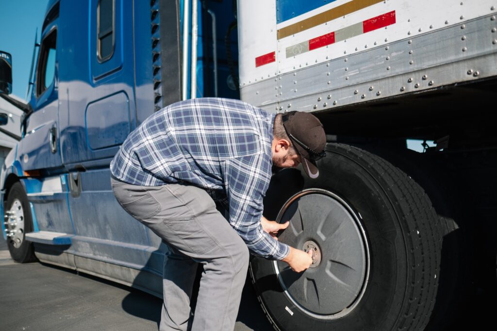 truck driver checking wheel